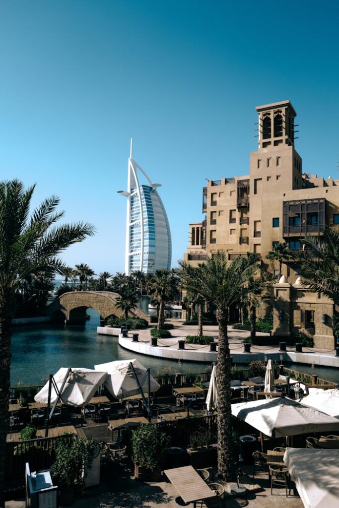 Scenic view of the Burj Al Arab with traditional Arabian architecture and palm trees in Dubai.